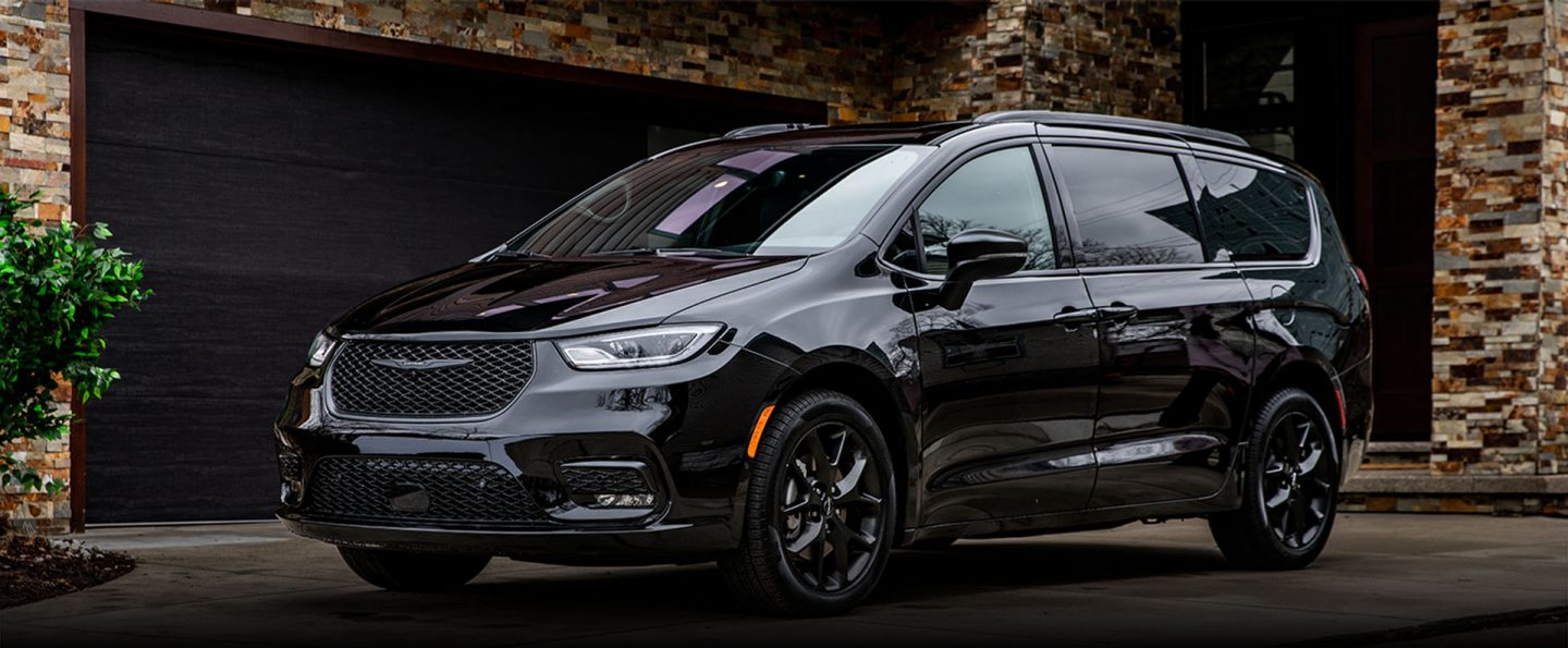 An angled driver-side profile of a black 2024 Chrysler Pacifica Limited with S Appearance Package
